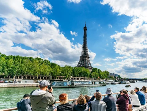 Eiffel Tower Seine River cruise boat passing the tower